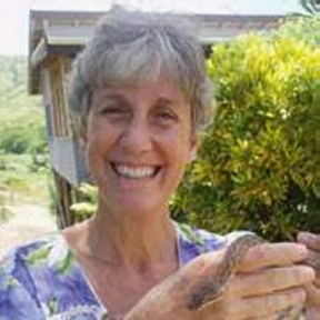 Kim Bowden-Kerby holding a little "friend" (snake) on lush Fiji